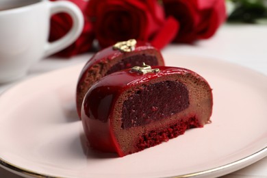Photo of St. Valentine's Day. Pieces of delicious cake served on table, closeup