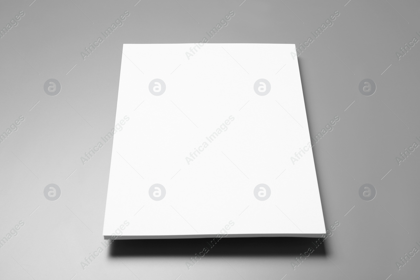 Photo of Blank paper sheets for brochure on grey background. Mock up