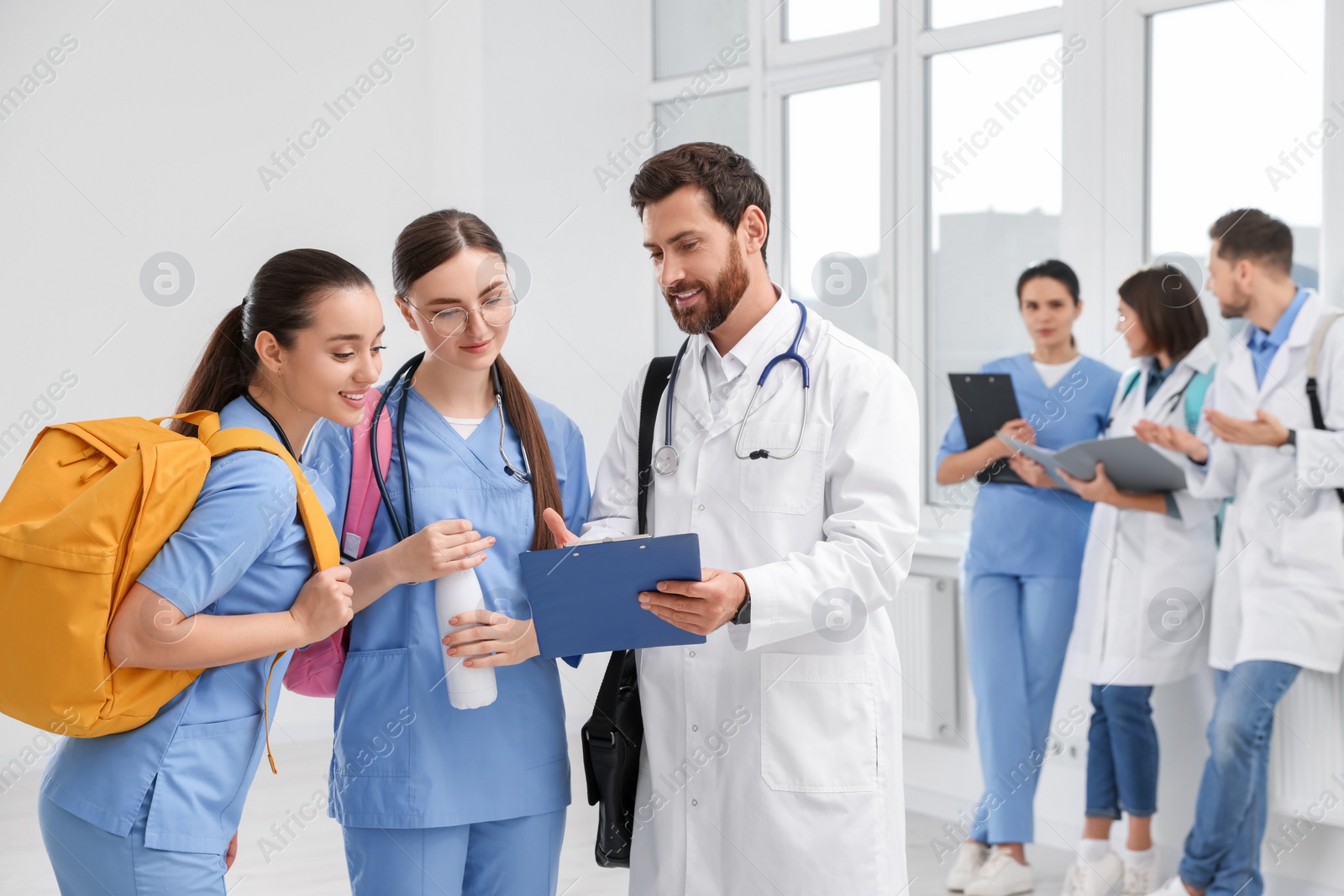Photo of Team of medical students in college hallway, space for text