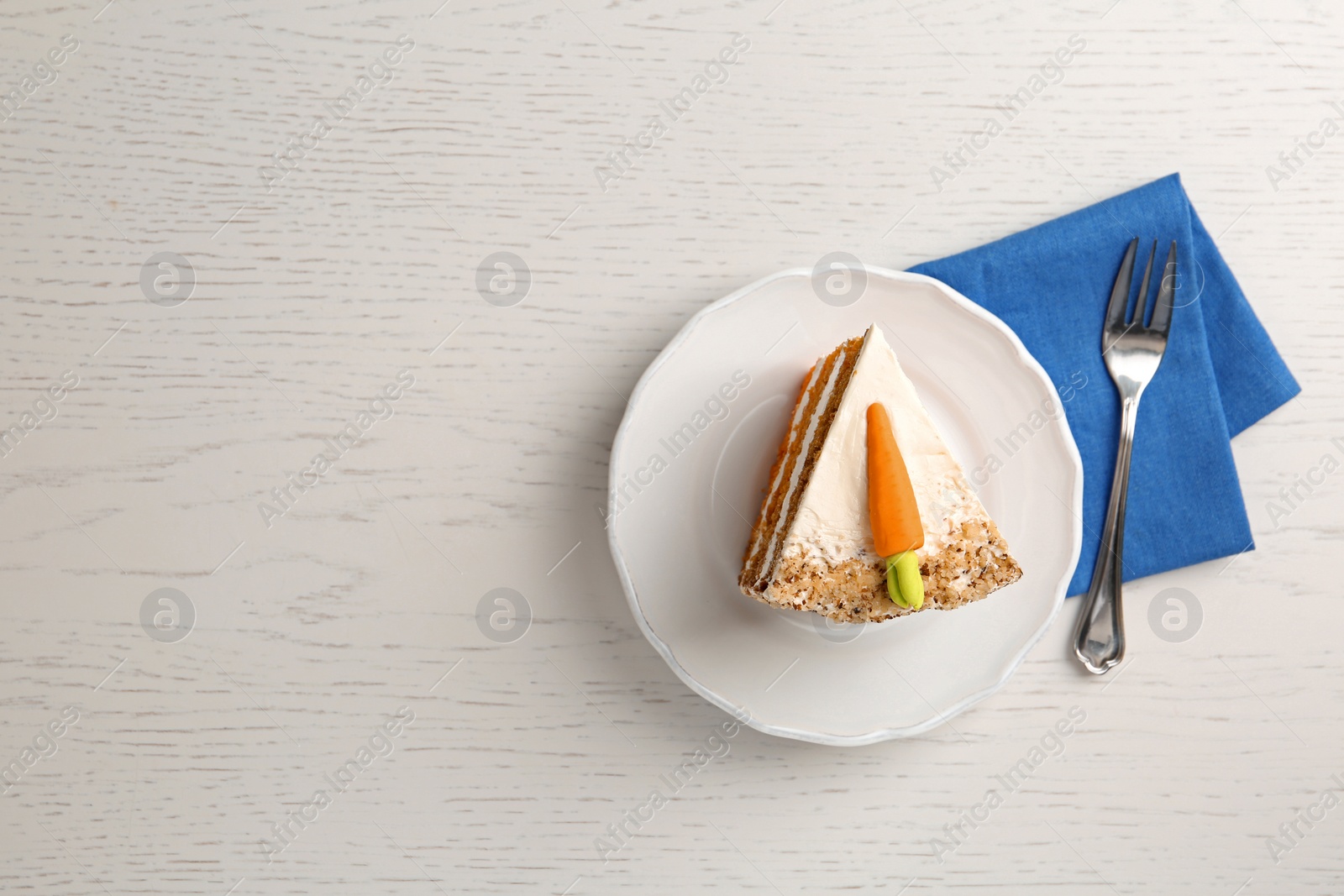 Photo of Flat lay composition with sweet carrot cake on table, space for text