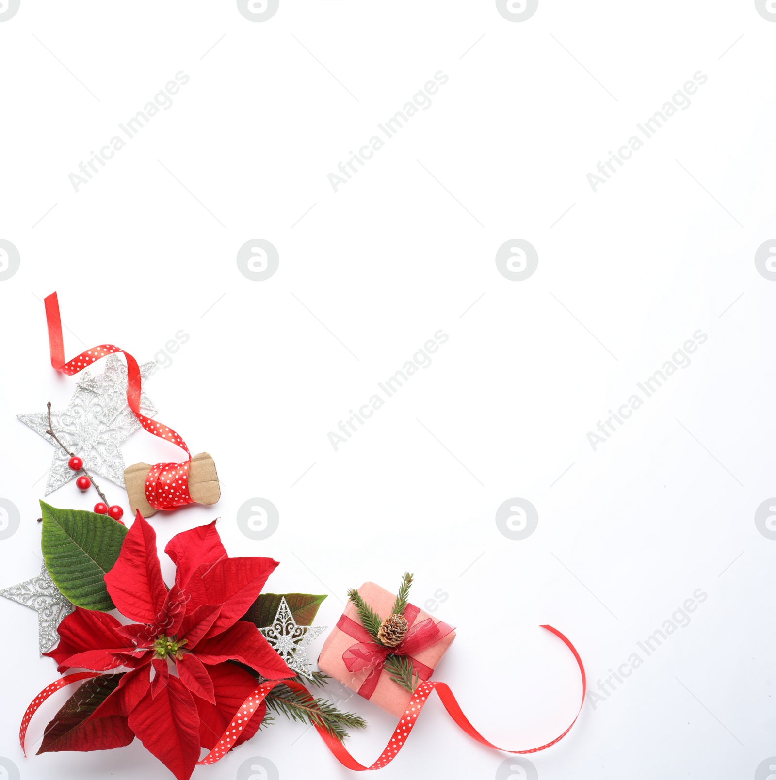 Photo of Flat lay composition with beautiful poinsettia and gift on white background, space for text. Christmas traditional flower