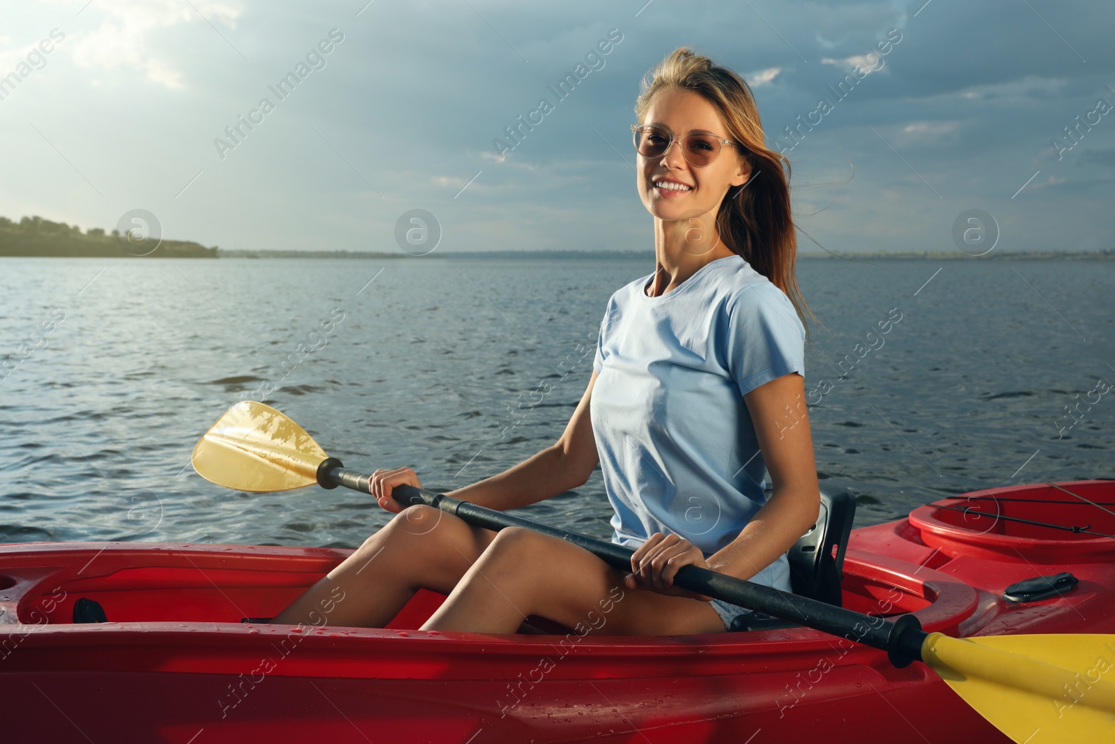 Photo of Happy woman kayaking on river. Summer activity