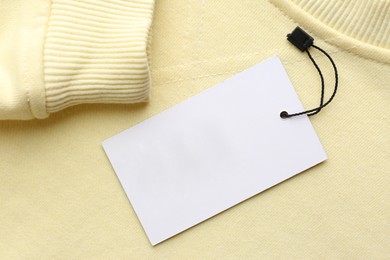 Photo of Blank tag on sweatshirt, top view. Space for text