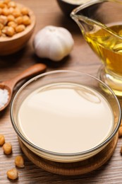 Photo of Different ingredients on wooden table. Cooking delicious hummus