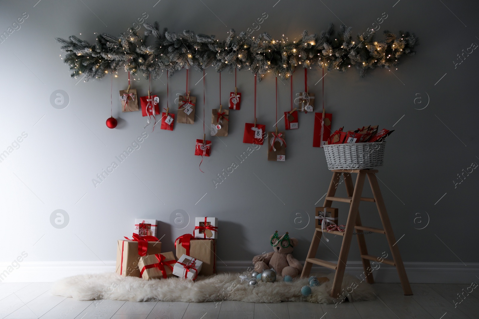 Photo of Christmas advent calendar hanging on wall above gift boxes