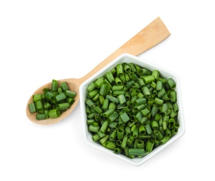 Bowl and spoon with chopped green onion on white background, top view