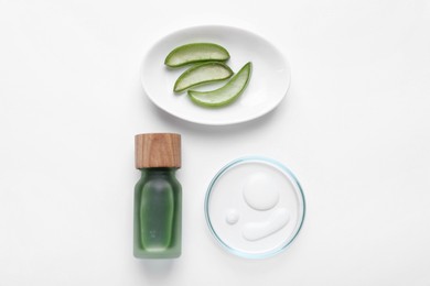 Photo of Cosmetic products and cut aloe leaves on white background, flat lay