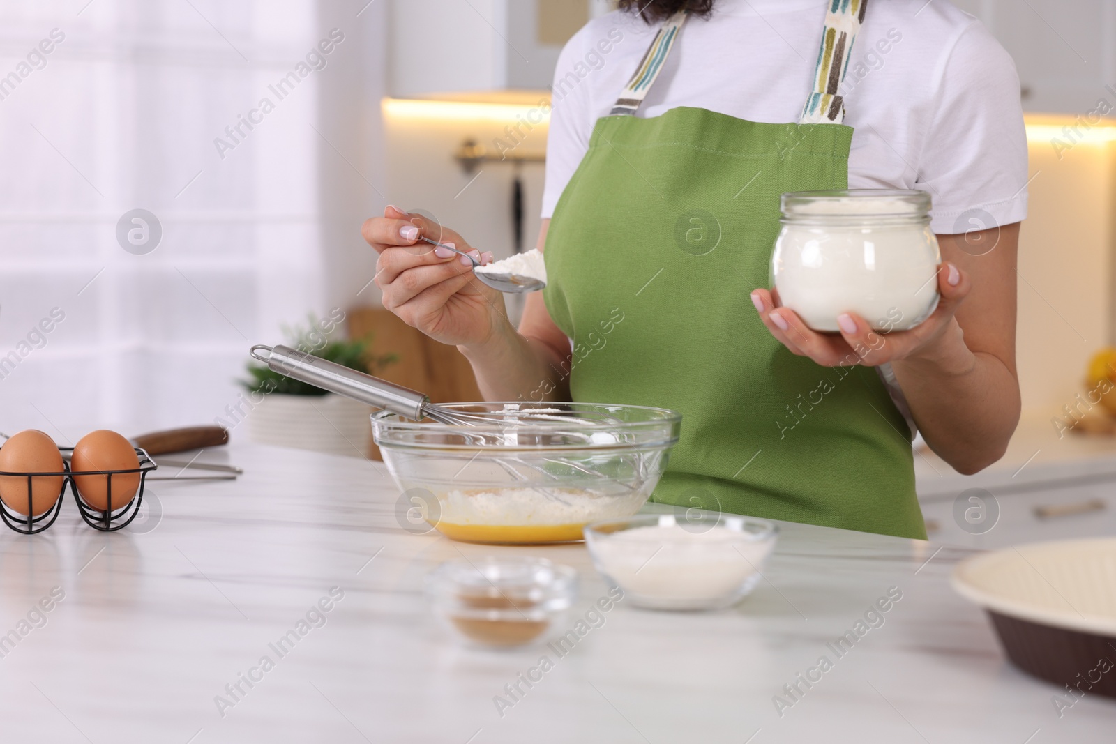 Photo of Food blogger cooking at white marble table in kitchen, closeup