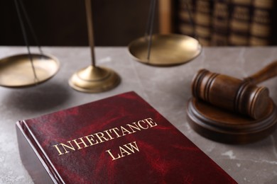 Inheritance law and gavel on grey marble table, closeup