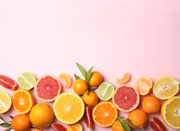 Photo of Different citrus fruits on color background, top view. Space for text