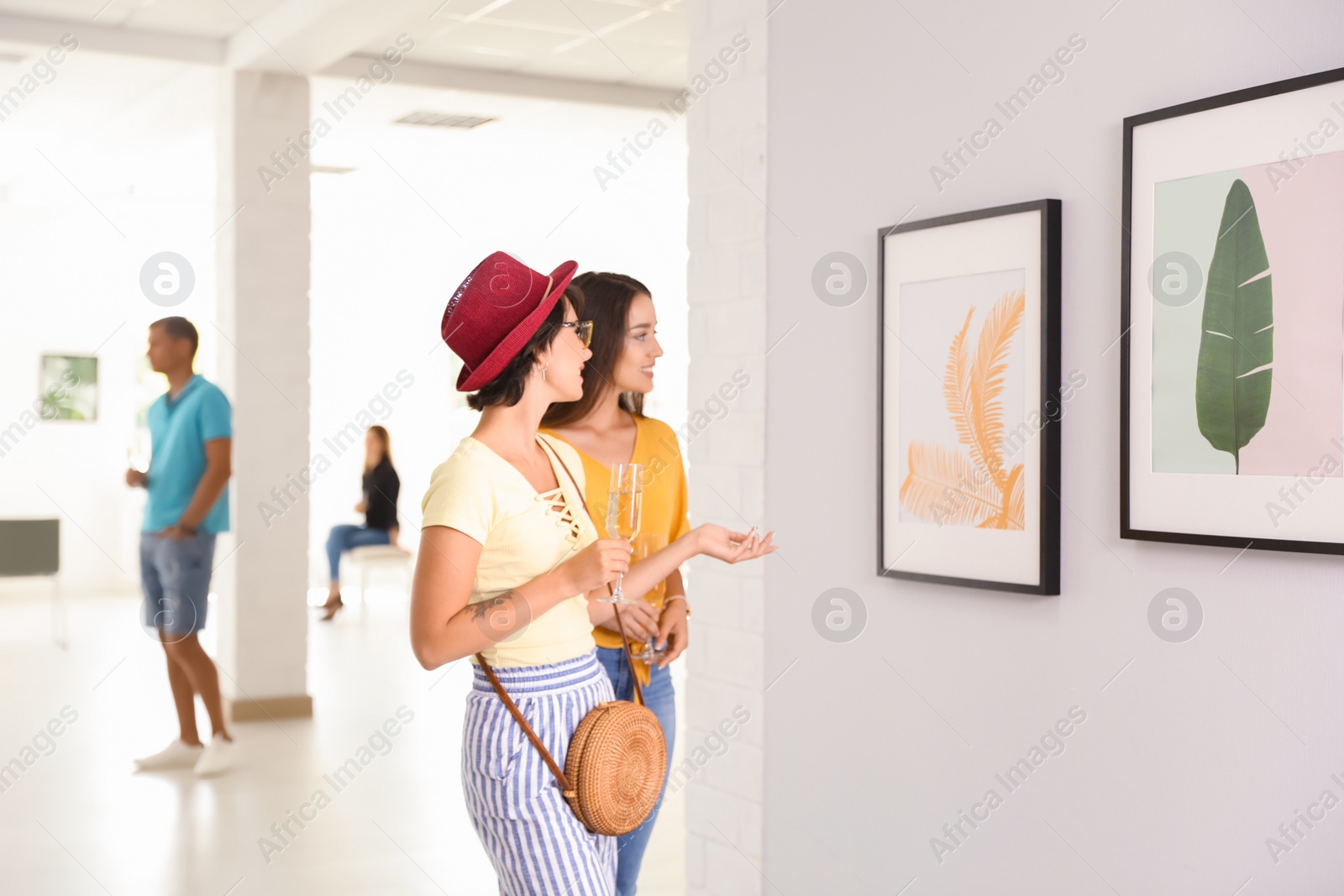 Photo of Young women at exhibition in art gallery