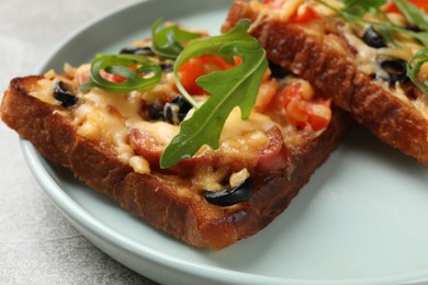 Photo of Tasty pizza toasts served on grey table, closeup
