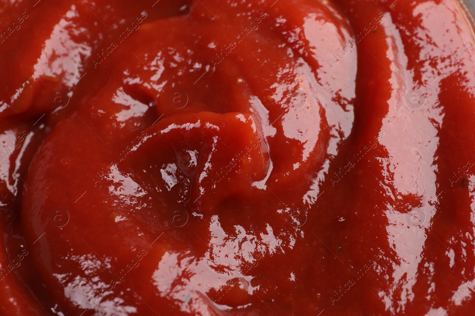 Photo of Organic ketchup as background, closeup. Tomato sauce