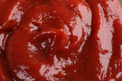 Organic ketchup as background, closeup. Tomato sauce