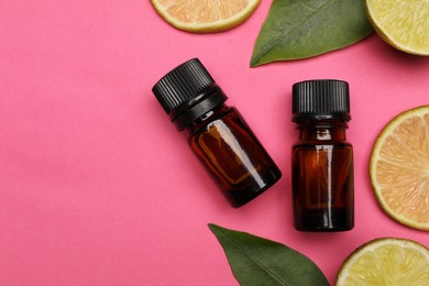 Photo of Bottlescitrus essential oil and fresh lime slices on pink background, flat lay. Space for text