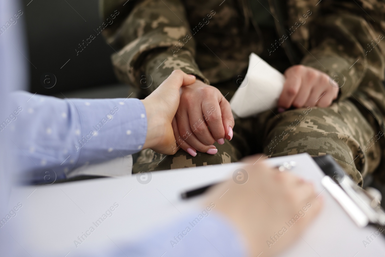 Photo of Psychotherapist working with military woman in office, closeup