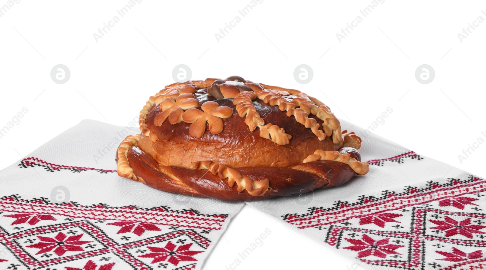 Photo of Rushnyk with korovai on white background. Ukrainian bread and salt welcoming tradition