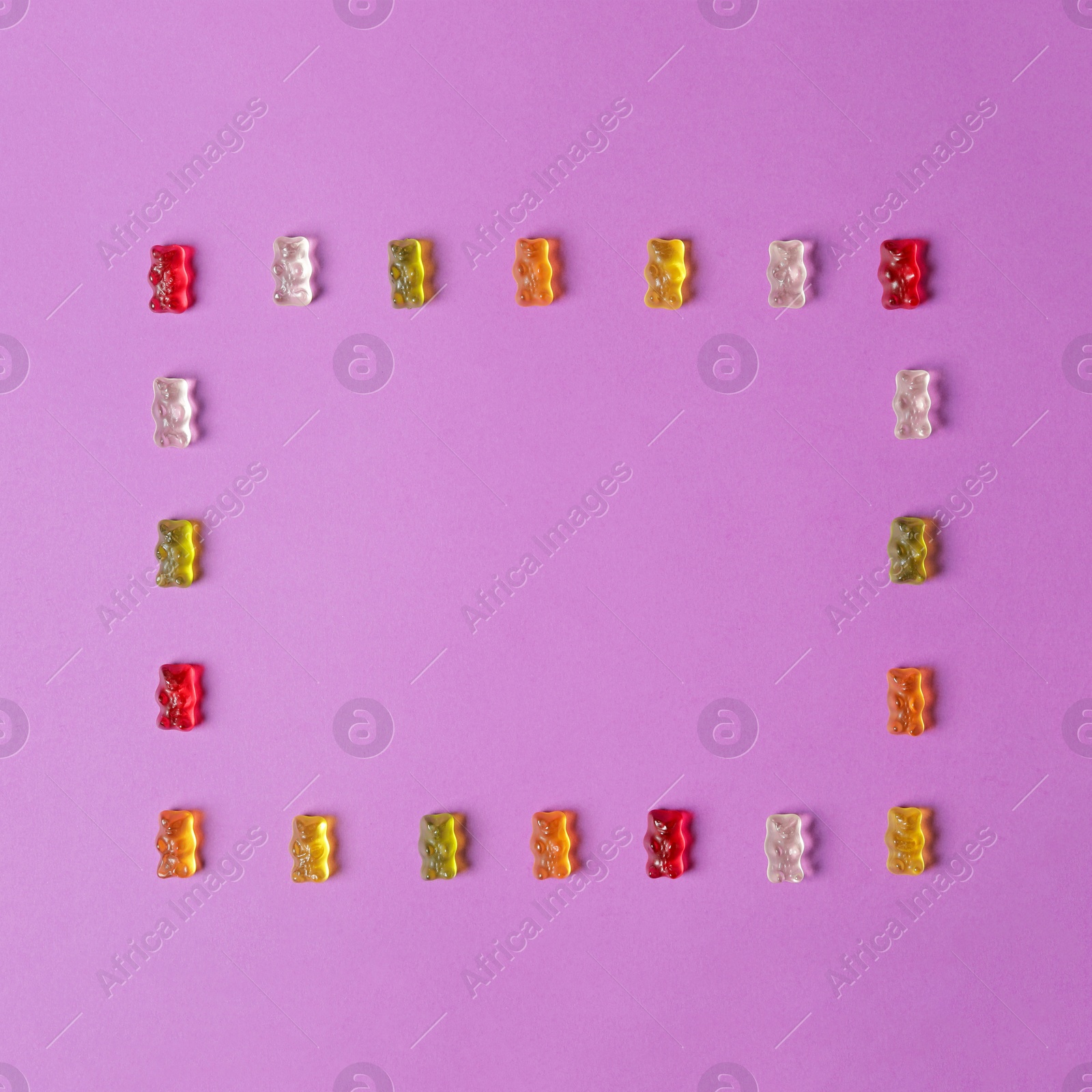 Photo of Flat lay composition with delicious jelly bears on color background. Space for text