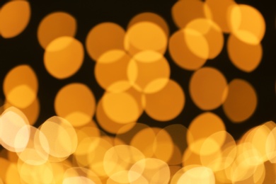 Photo of Beautiful golden lights on dark background. Bokeh effect