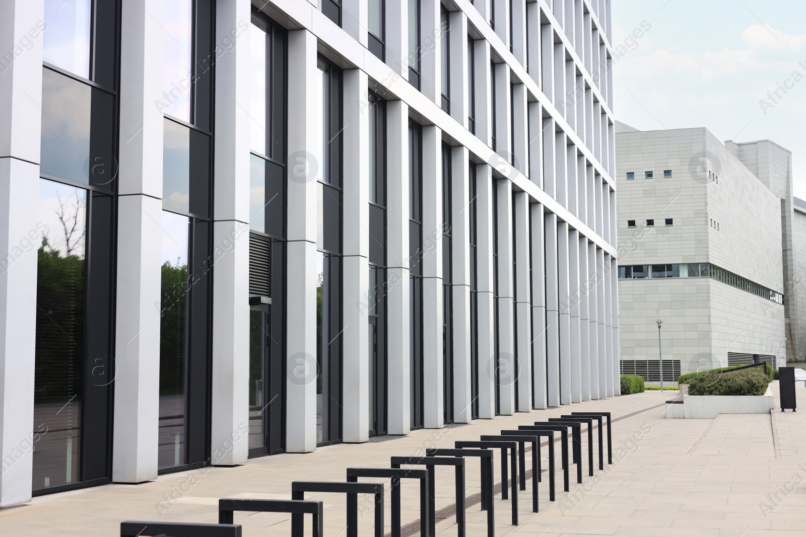 Photo of Beautiful view of modern building and bicycle stands on city street