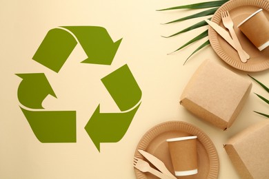 Image of Flat lay composition with eco friendly products and recycling symbol on beige background