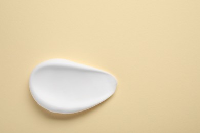 Photo of Sample of shaving foam on beige background, top view. Space for text