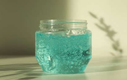 Photo of Jar of blue cosmetic gel on light table