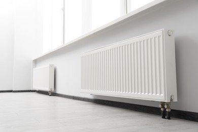 Photo of Modern radiators in room. Central heating system