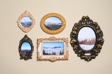 Vintage frames with photos of beautiful landscapes hanging on beige wall