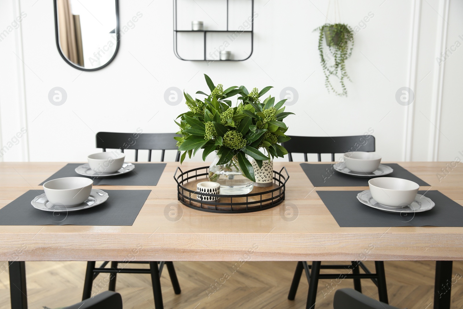 Photo of Stylish wooden dining table and chairs in room. Interior design