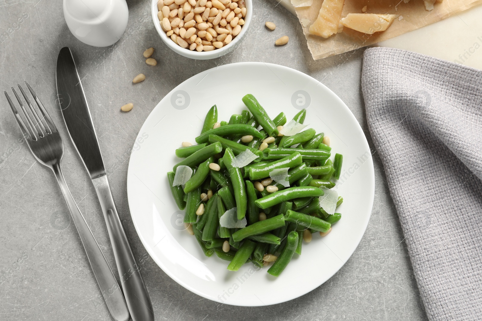 Photo of Tasty salad with green beans served on light grey table, flat lay