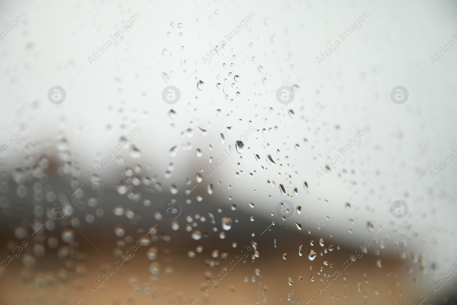 Photo of Window glass with water drops, closeup. Rainy weather