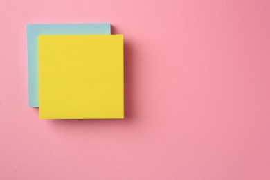 Photo of Blank paper notes on pink background, top view. Space for text
