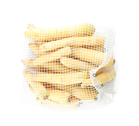 Raw carrots in mesh bag isolated on white, top view
