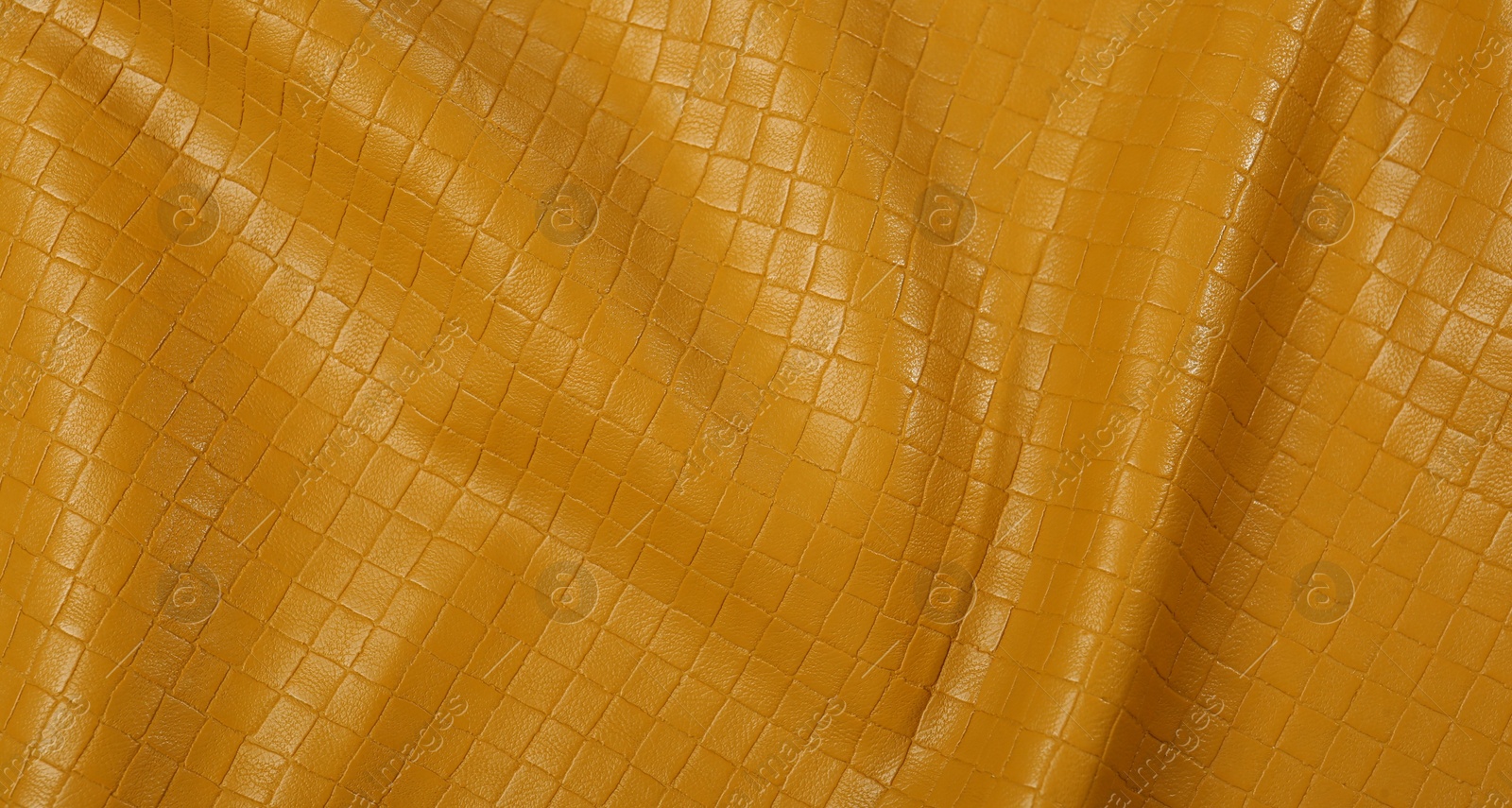 Photo of Beautiful yellow leather as background, top view