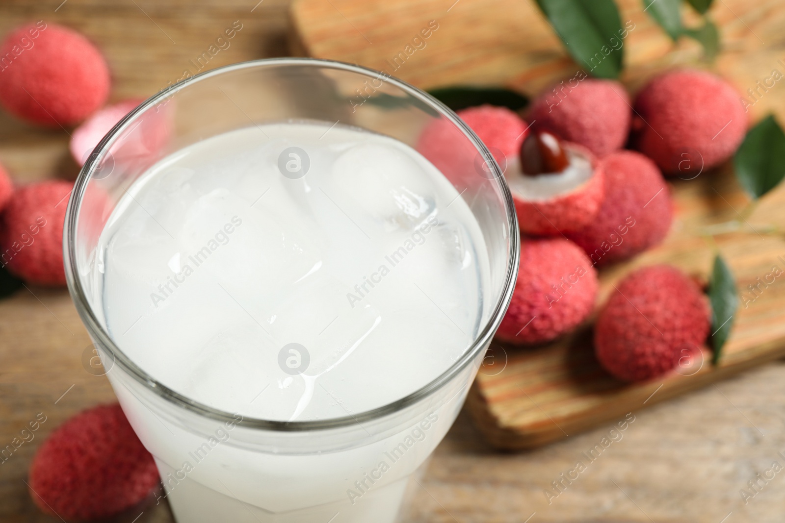 Photo of Glass with fresh lychee juice on table, closeup