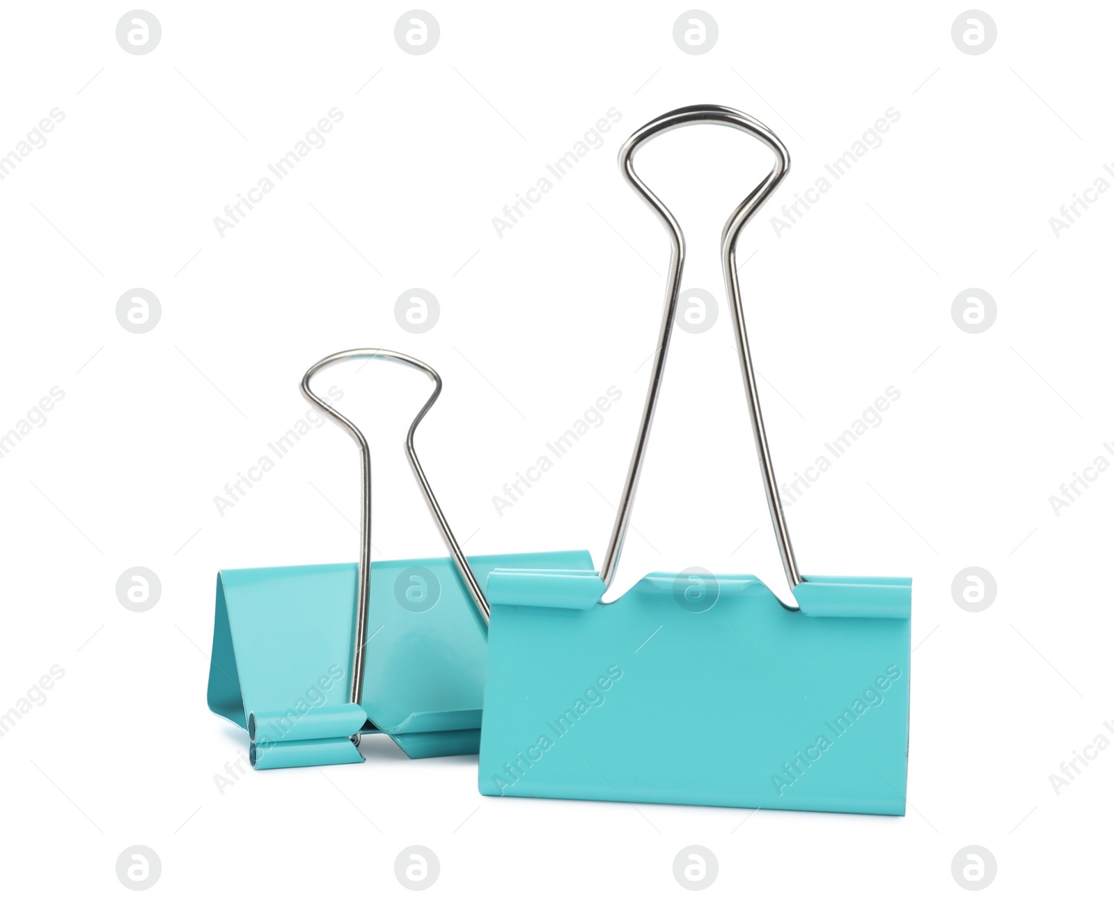 Photo of Turquoise binder clips on white background. Stationery