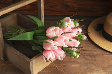 Photo of Beautiful bouquet of spring pink tulips on wooden table