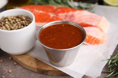 Tasty fish marinade and products on table, closeup