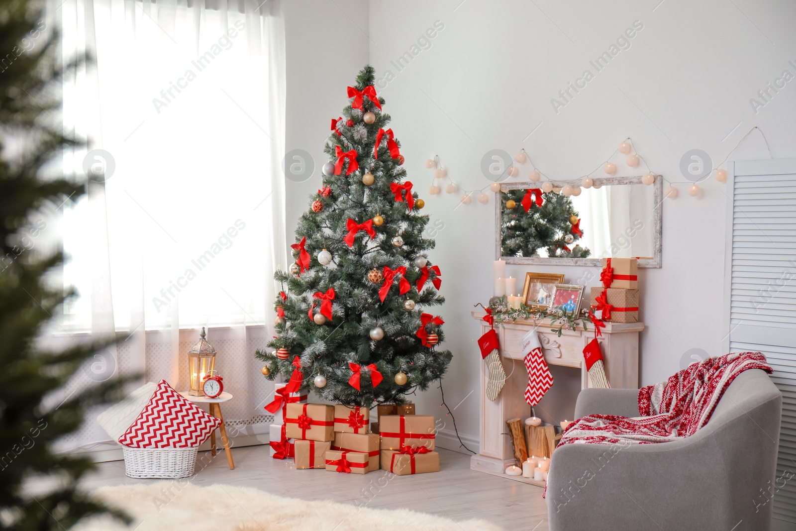 Photo of Stylish living room interior with decorated Christmas tree