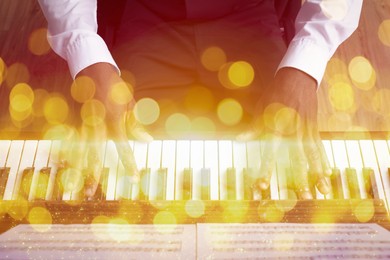 Image of Christmas and New Year music. Man playing piano indoors, bokeh effect