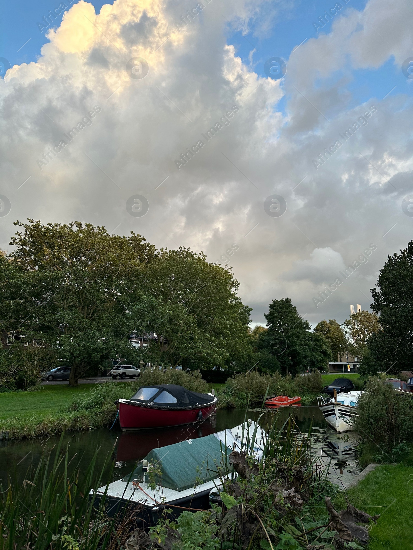 Photo of Canal with moored boats under beautiful sky