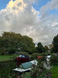 Photo of Canal with moored boats under beautiful sky