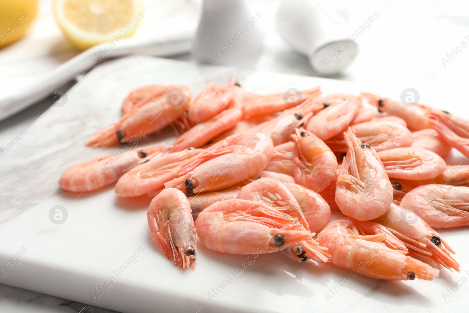 Photo of Fresh raw shrimps on board, closeup