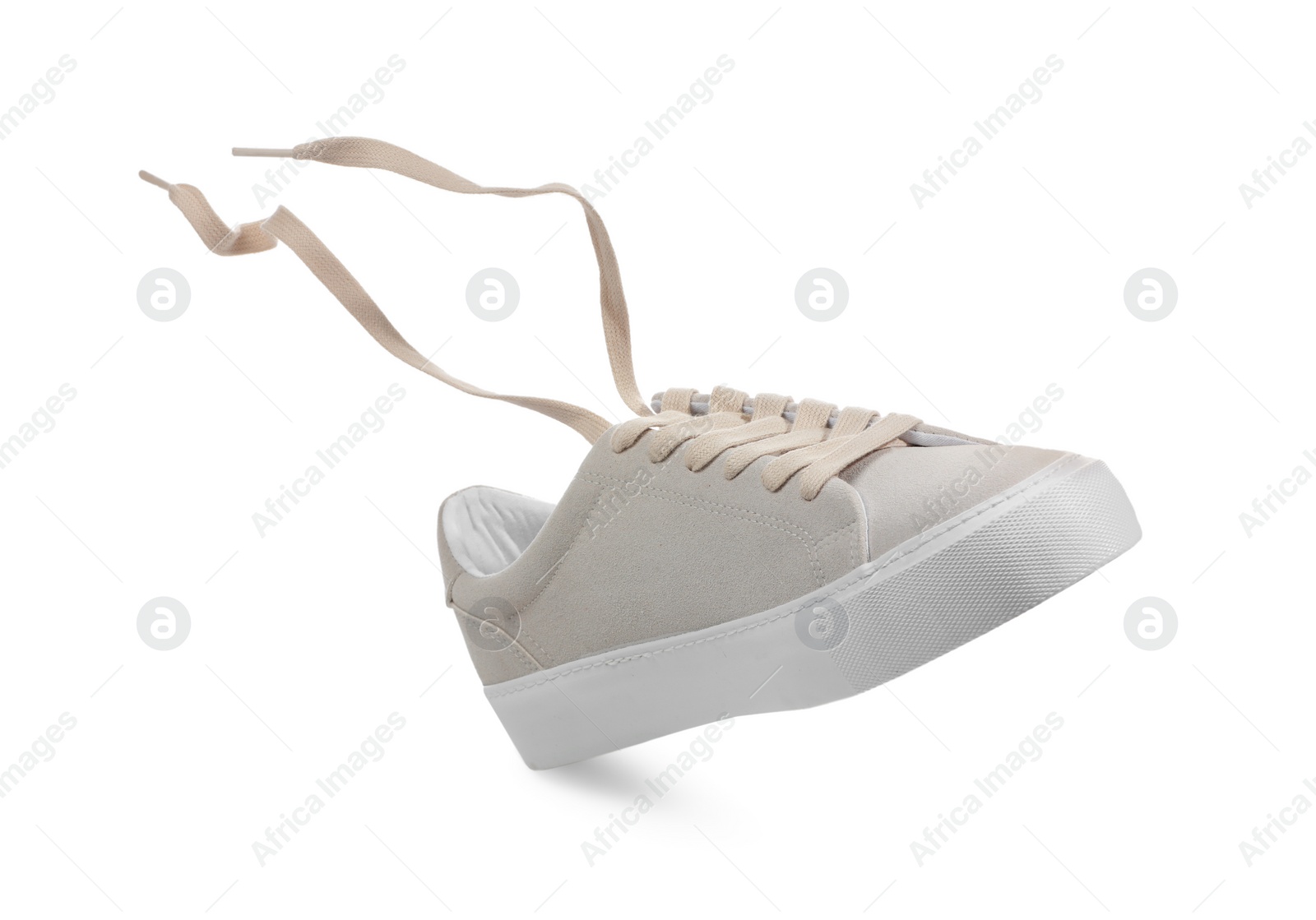 Photo of One stylish beige sneaker isolated on white