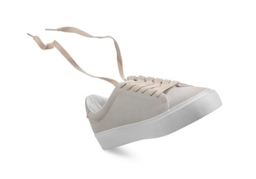 Photo of One stylish beige sneaker isolated on white