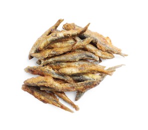 Pile of delicious fried anchovies on white background, top view