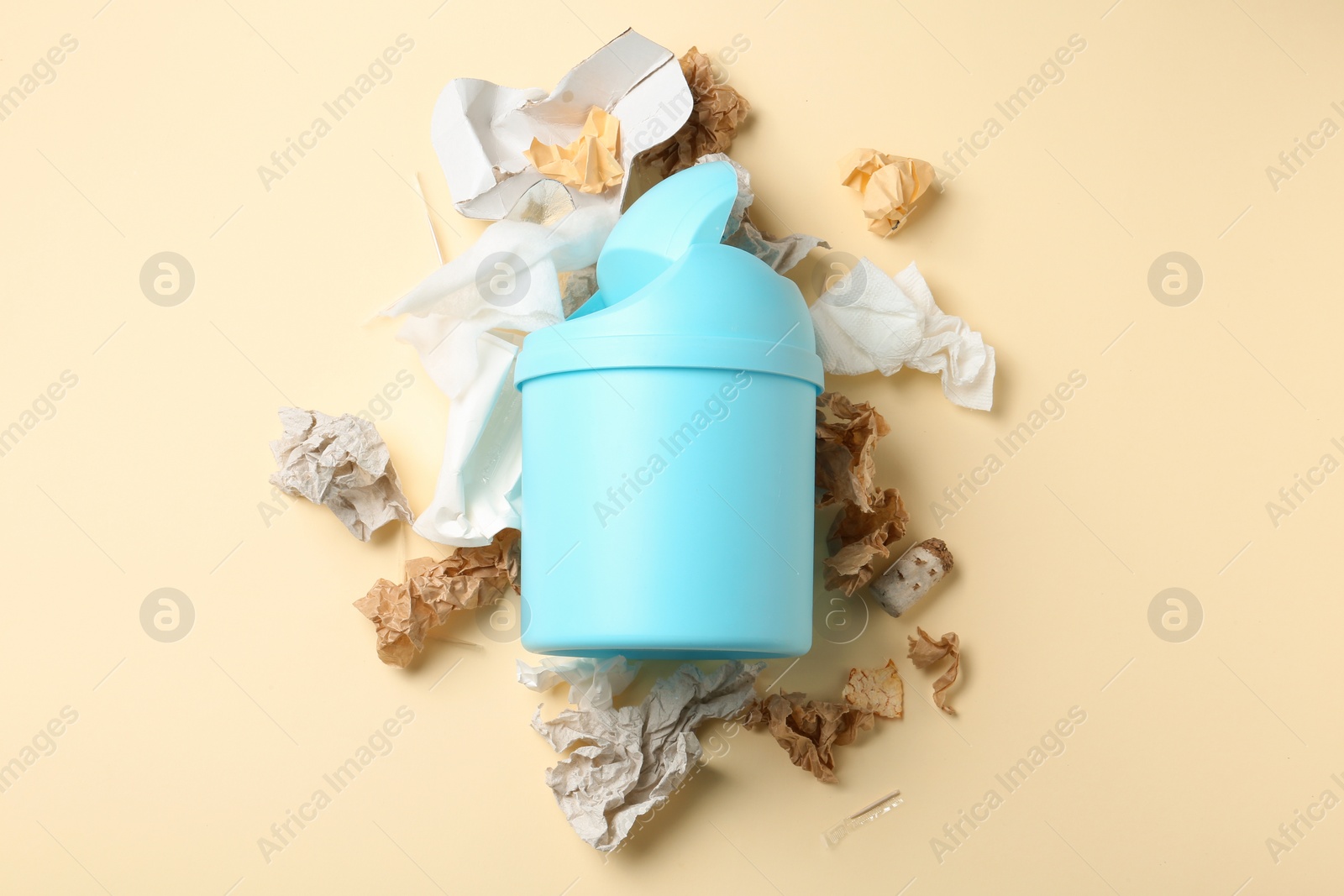 Photo of Trash bin and different garbage on color background, top view. Waste recycling concept