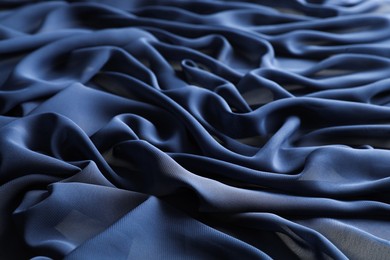 Photo of Beautiful dark blue tulle fabric as background, closeup