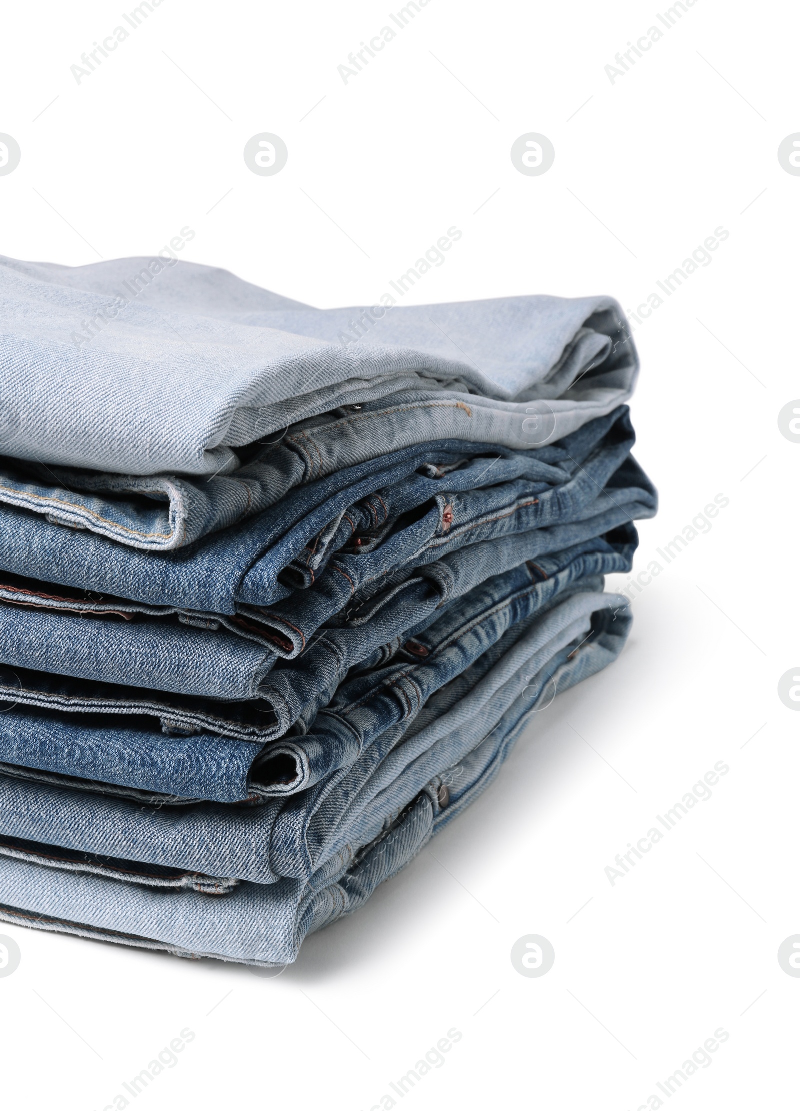 Image of Stack of different folded jeans isolated on white